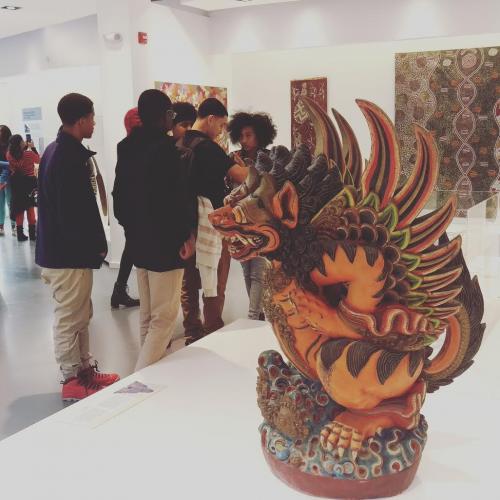 Students discuss anthropology in front of a winged lion (singa) from Indonesia.